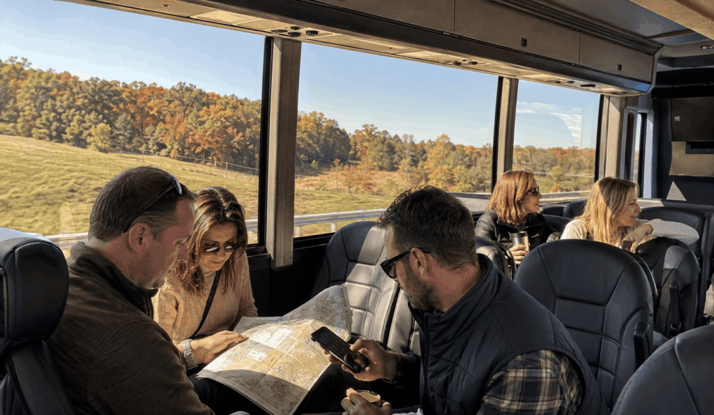 group riding a charter bus from indianapolis to brown county while planning their day trip