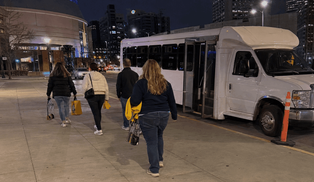 fans walking back to a party bus after a Pacers or Fever game in downtown Indianapolis