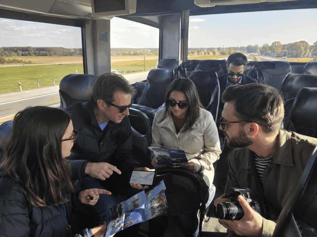 group riding from indianapolis to chicago inside a charter bus with maps and sightseeing bags