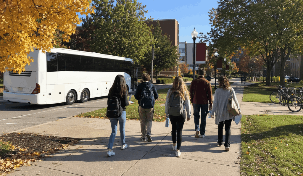 students arriving by charter bus for a college campus visit from indianapolis