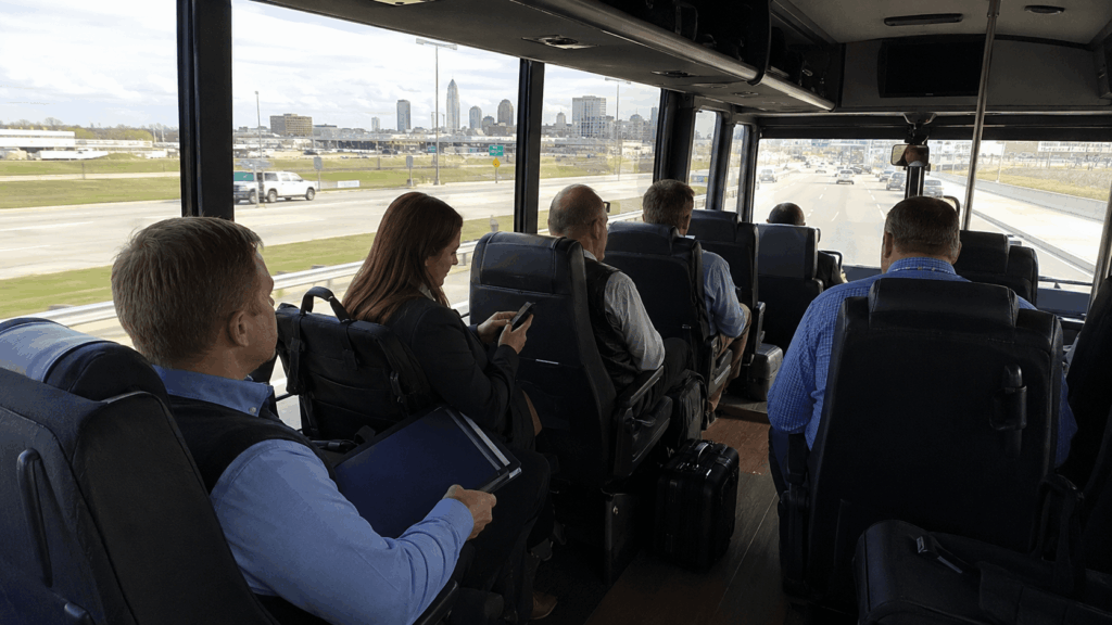corporate team riding inside a clean shuttle bus after landing at indianapolis international airport.