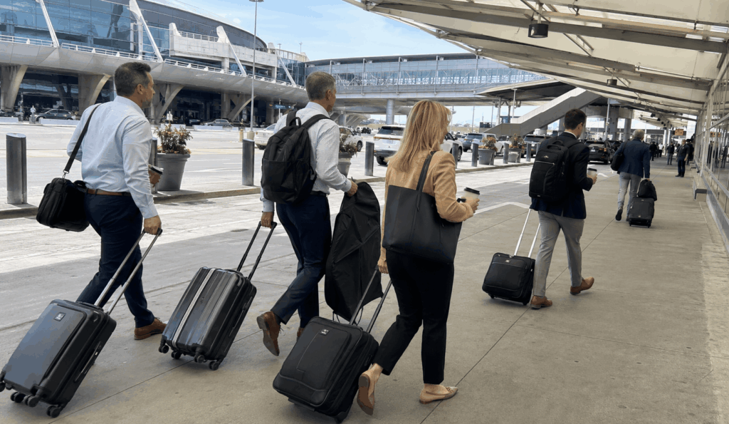 corporate travelers arriving together at indianapolis international airport for a team transfer.