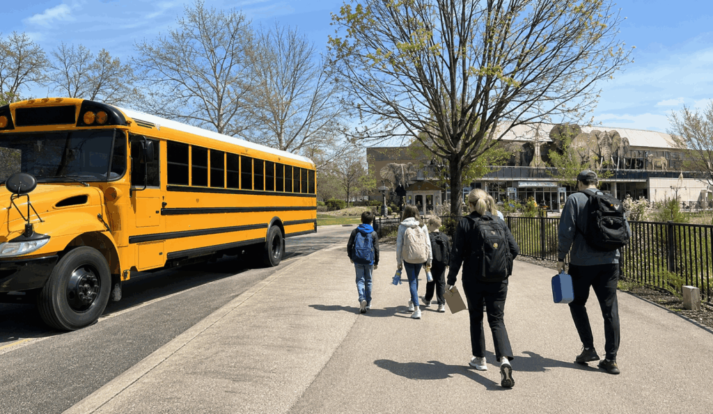 teachers and students loading a minibus for an indianapolis museum and zoo field trip