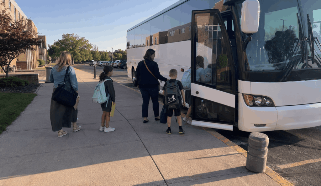 school group boarding a charter bus for a field trip in indianapolis