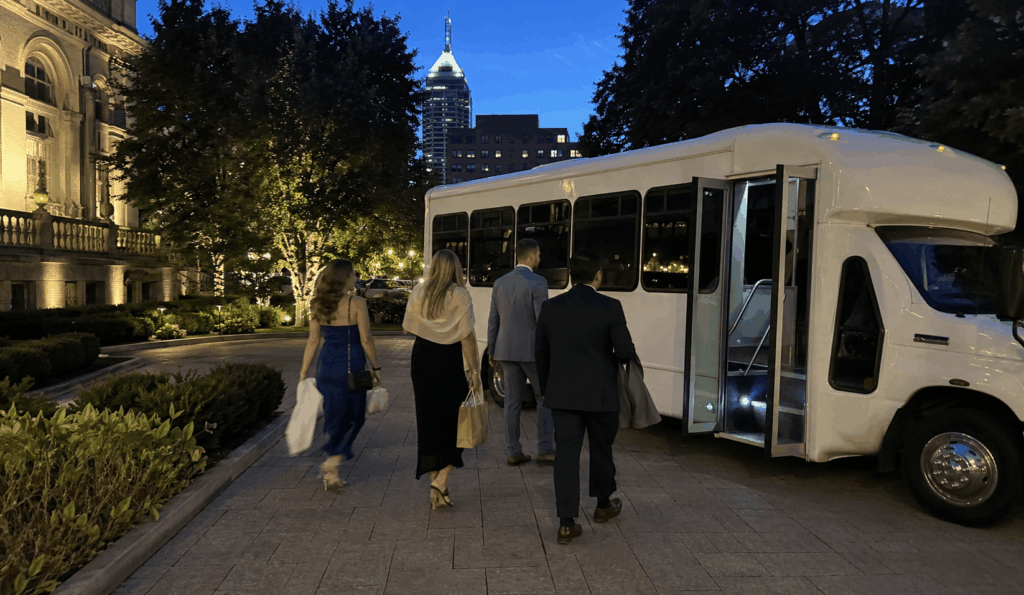 Wedding guests boarding a shuttle bus outside an Indianapolis wedding venue after the reception