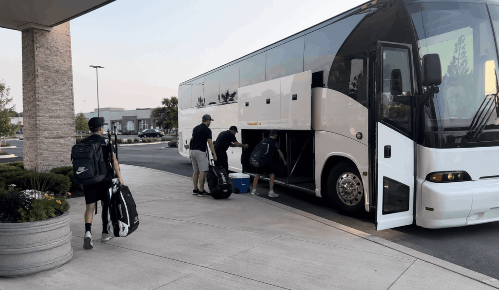 youth travel team boarding a charter bus for a tournament weekend near indianapolis